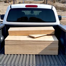 construction worker loading wood debris into a junk removal truck