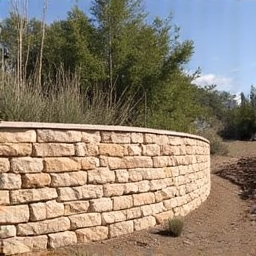 Decorative boulder retaining wall for slope stabilization and aesthetic appeal in a hilly area